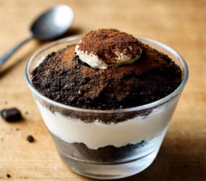 A rich and creamy Oreo Tiramisu dessert layered with mascarpone cream and crushed Oreo cookies in a glass dish.