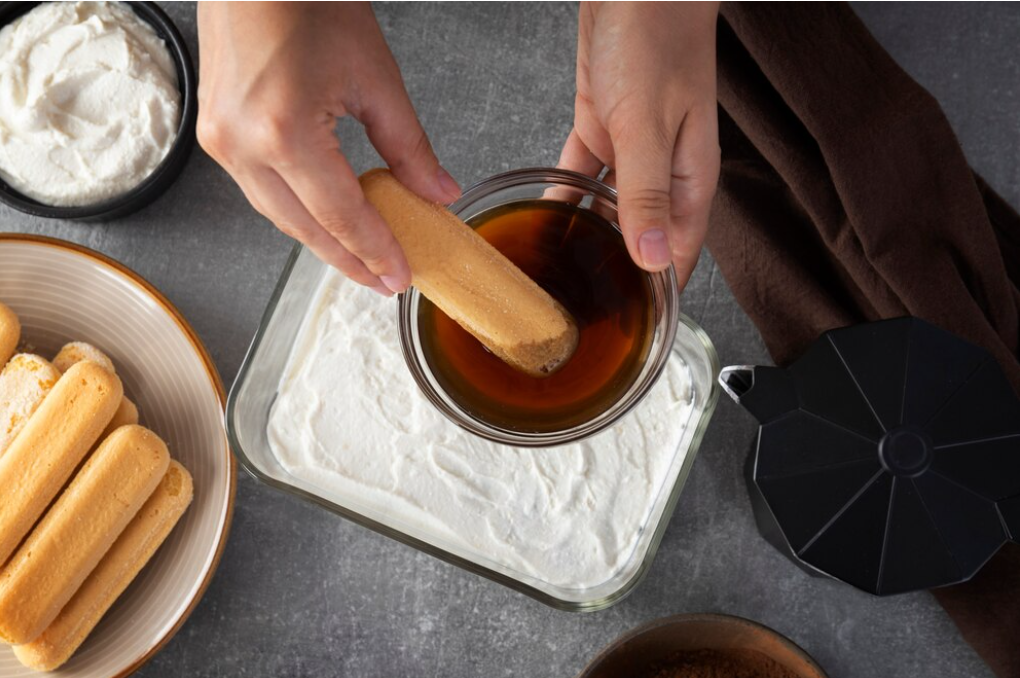 A step-by-step visual showing coffee-soaked ladyfingers being layered with mascarpone cream in a glass dish.