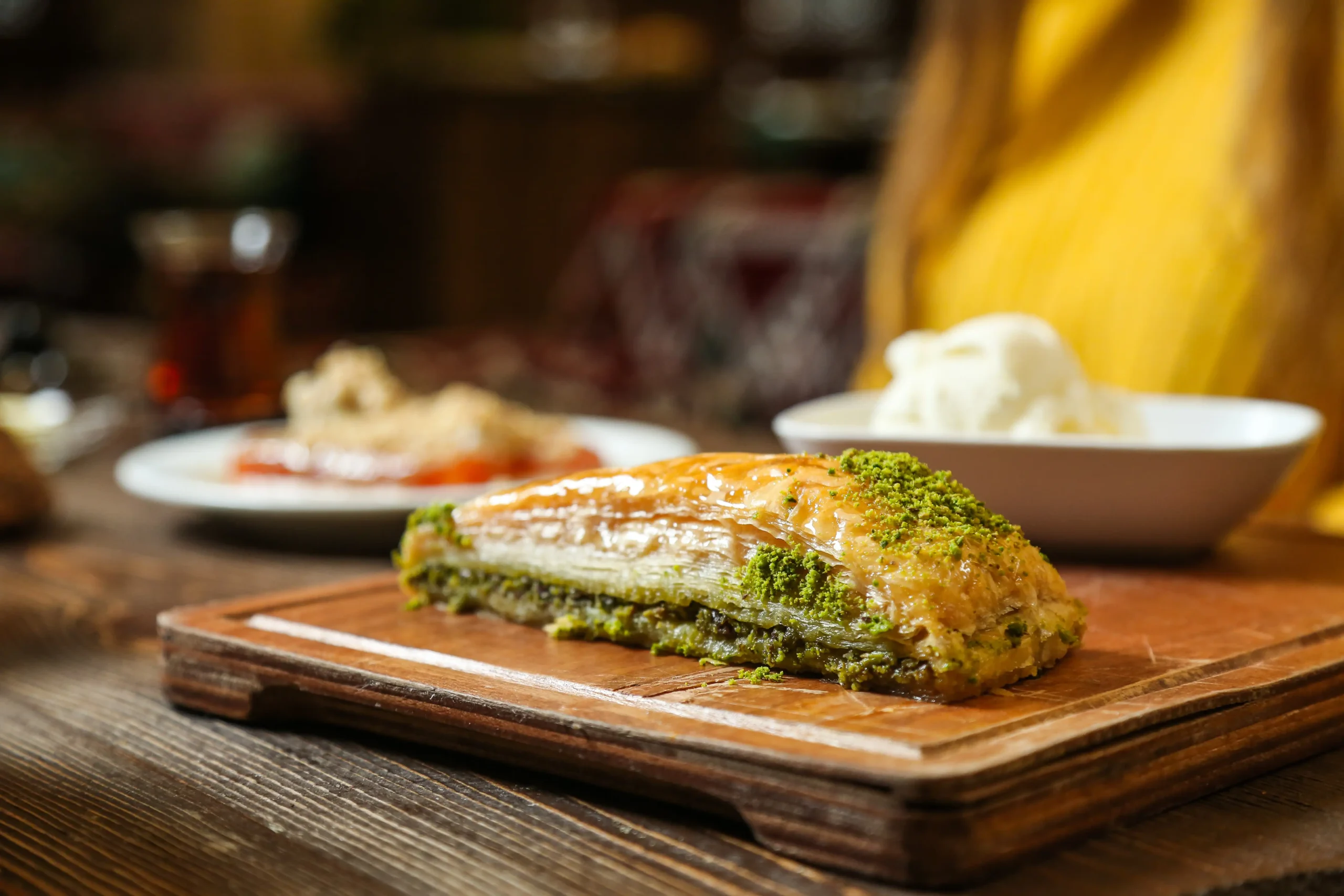 Most Famous Arabic Desserts: Baklava, Kunafa & More 2 A plate of golden Baklava pieces, freshly made and syrup-drenched.