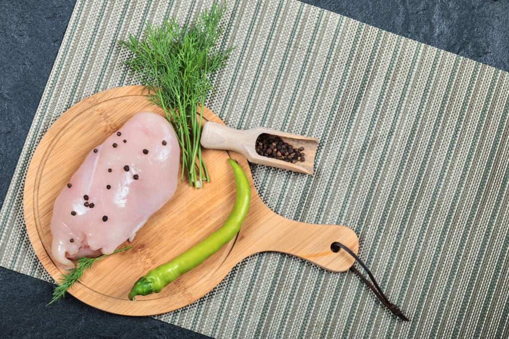 A raw turkey breast soaking in a flavorful brine with garlic