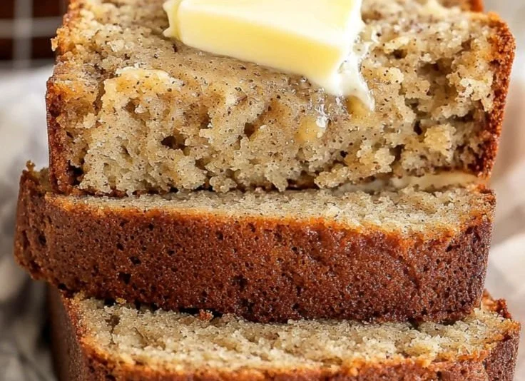 Slice of easy moist banana bread on a wooden cutting board