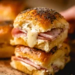 Deliciously cheesy ham and cheese sliders served on a platter