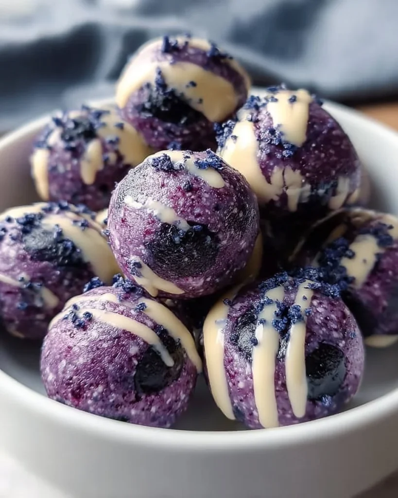 Delicious Blueberry Cheesecake Protein Bites on a wooden table