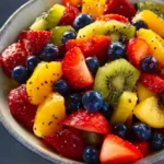 Colorful fresh fruit salad with honey lime poppy seed dressing