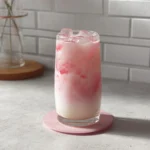 Making a refreshing pink drink at home with ingredients and recipe steps.