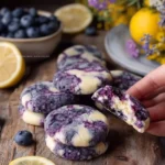 Lemon Blueberry Cheesecake Cookies on a plate with fresh blueberries
