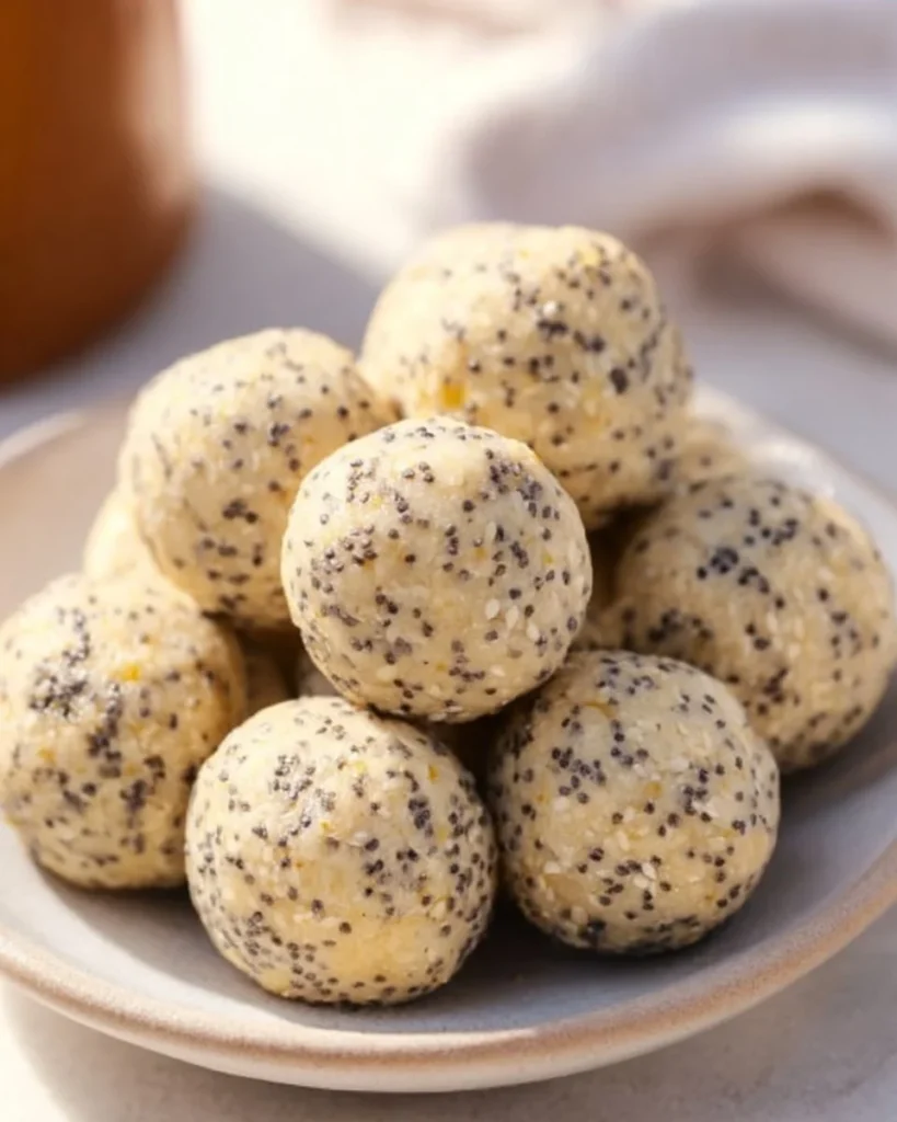 Delicious lemon poppy seed energy bites arranged on a plate.