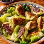 Plate of low carb cabbage dumplings garnished with herbs