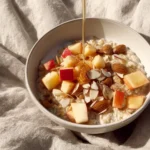 Delicious apple cinnamon oatmeal bowl topped with fresh apples and cinnamon.