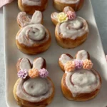 Easter Bunny cinnamon rolls decorated with icing and colorful sprinkles