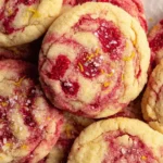 Freshly baked lemon raspberry cookies on a cooling rack