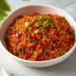 Plate of spicy Schezwan Fried Rice garnished with vegetables and herbs
