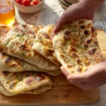 Delicious butter chicken flatbread topped with aromatic spices and herbs.