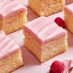 Easy almond cake with icing and almonds on a wooden table
