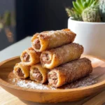 Delicious French Toast Rolls served with syrup and berries