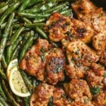 Lemon garlic butter chicken thighs garnished with herbs on a plate
