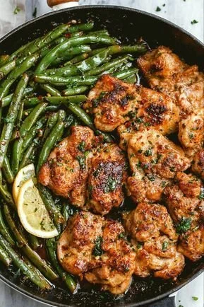 Lemon garlic butter chicken thighs garnished with herbs on a plate