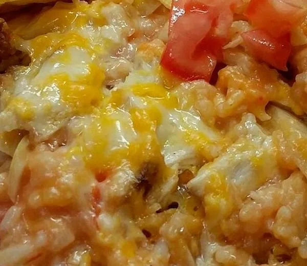 Salsa Chicken Rice Casserole baked in a vibrant dish, topped with cheese and herbs.